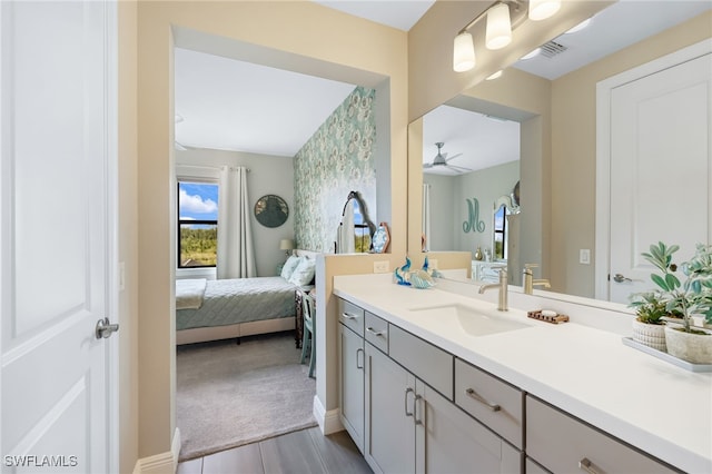 bathroom with hardwood / wood-style flooring, ceiling fan, and vanity