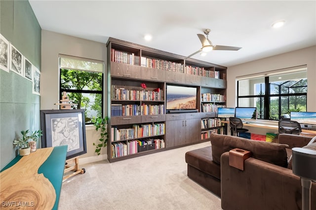 sitting room featuring ceiling fan and light carpet