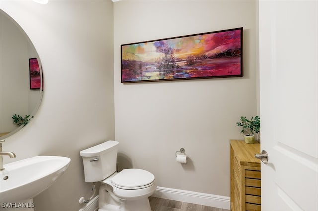 bathroom featuring hardwood / wood-style floors, toilet, and sink