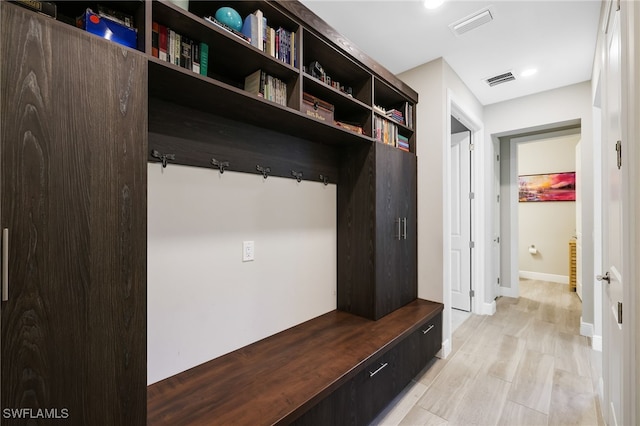 mudroom with light hardwood / wood-style floors