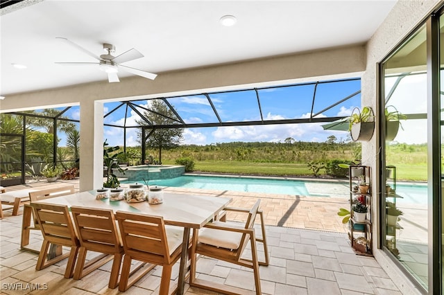 view of pool with a patio area, an in ground hot tub, ceiling fan, and glass enclosure