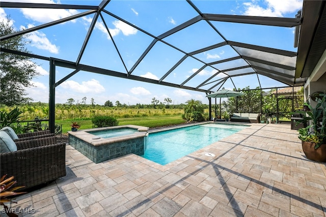 view of pool featuring glass enclosure, an in ground hot tub, and a patio