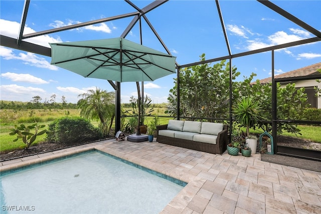 view of pool featuring glass enclosure and a patio area