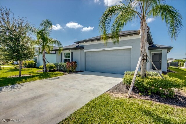 single story home featuring a garage and a front lawn