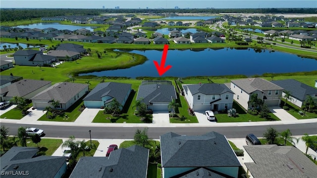 bird's eye view with a residential view and a water view