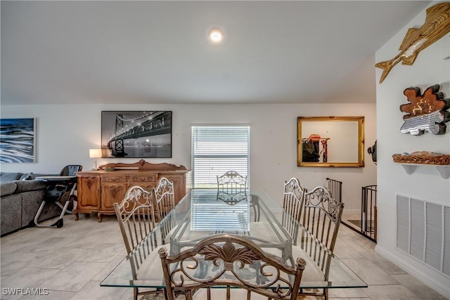 dining area with light tile patterned floors and visible vents