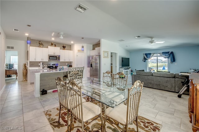 tiled dining area featuring ceiling fan