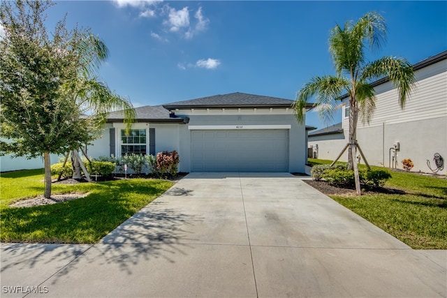 view of front facade featuring a garage, concrete driveway, a front yard, and stucco siding