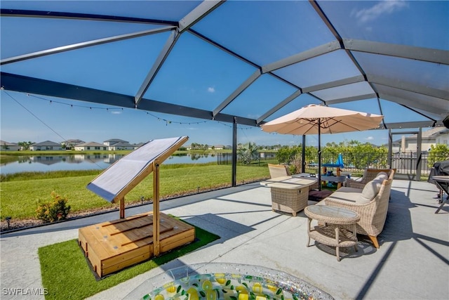 view of patio / terrace featuring a water view and fence