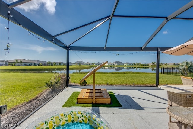 view of community with a yard, a water view, and a patio