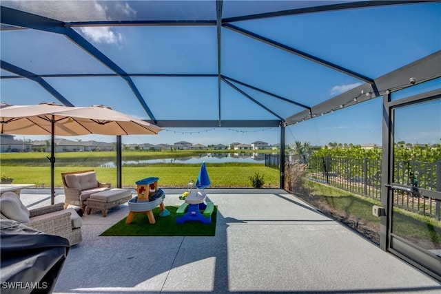 view of patio / terrace with a water view and fence