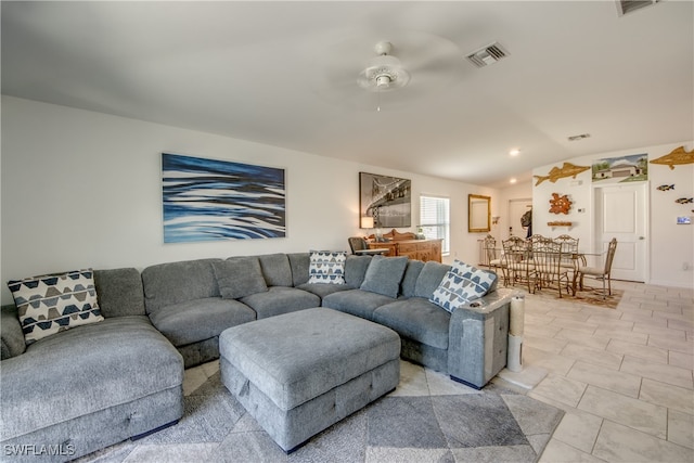 tiled living room featuring ceiling fan and vaulted ceiling