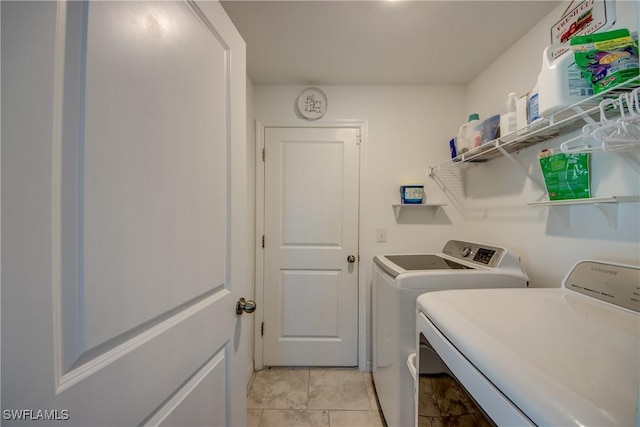 clothes washing area with laundry area and washer and dryer