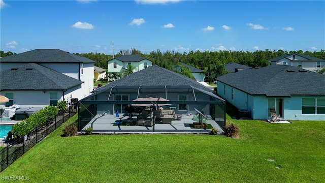 back of property with a lanai, a yard, a patio, and a swimming pool