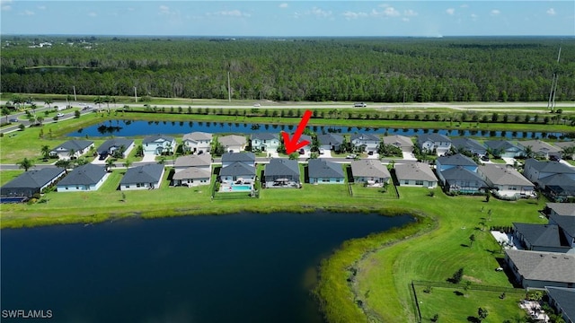 aerial view featuring a water view, a residential view, and a view of trees