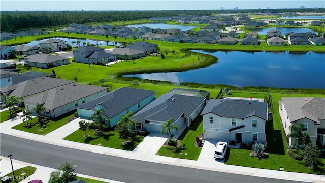 drone / aerial view featuring a water view and a residential view