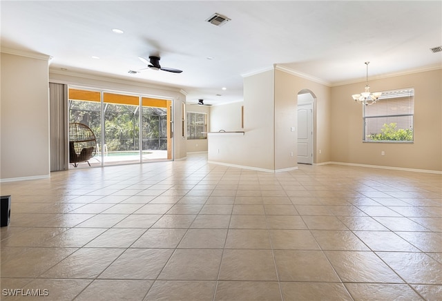 tiled spare room with ornamental molding, ceiling fan with notable chandelier, and a healthy amount of sunlight