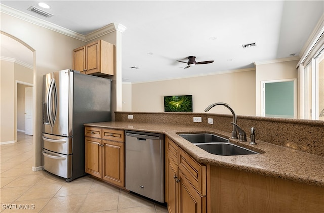 kitchen with ceiling fan, crown molding, light tile patterned flooring, stainless steel appliances, and sink