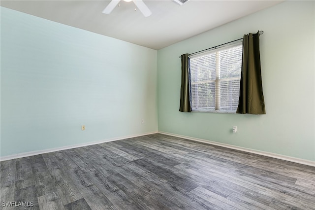 spare room with ceiling fan and wood-type flooring