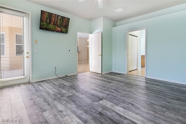 spare room with hardwood / wood-style floors and ceiling fan