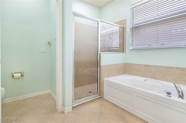 bathroom featuring shower with separate bathtub, tile patterned floors, and toilet