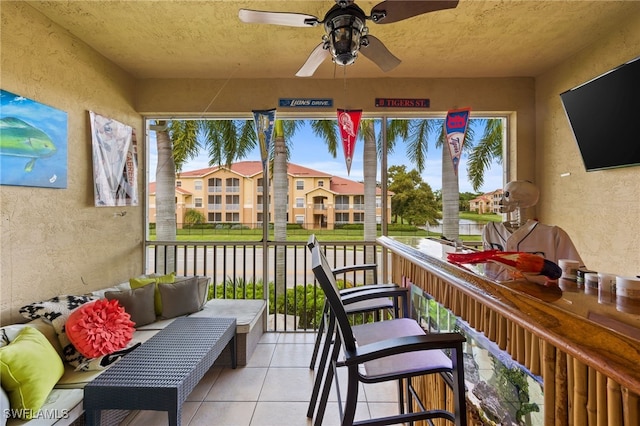 sunroom featuring ceiling fan