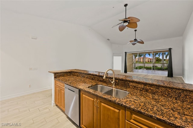 kitchen with sink, dark stone countertops, dishwasher, and ceiling fan