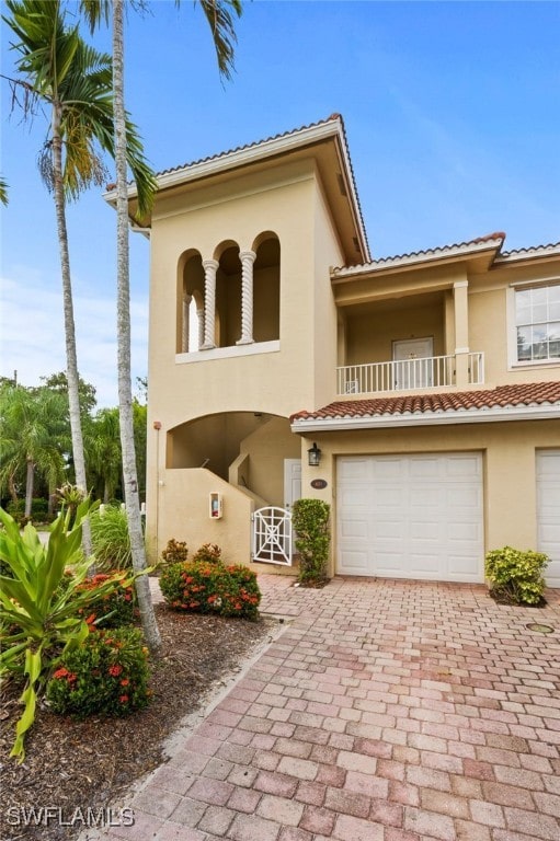 mediterranean / spanish house featuring a balcony and a garage