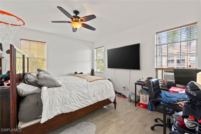 bedroom with ceiling fan and light wood-type flooring