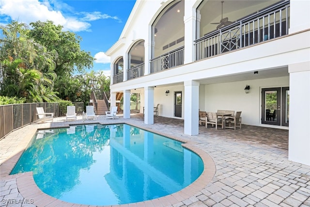 view of pool with ceiling fan and a patio area