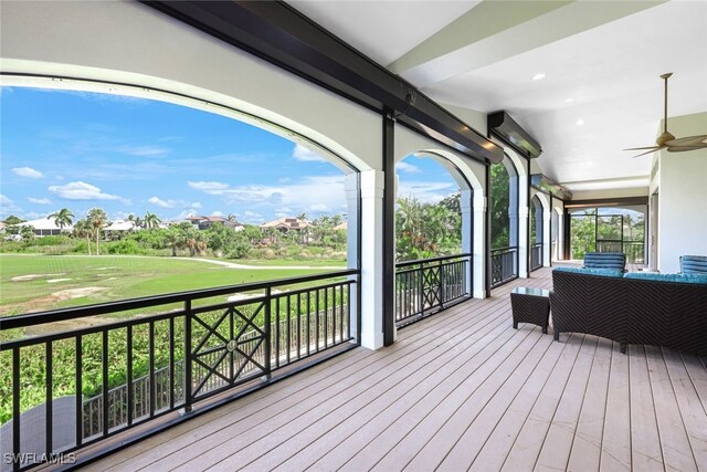 wooden deck featuring an outdoor hangout area and ceiling fan