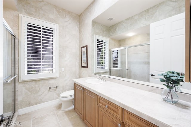 bathroom featuring toilet, walk in shower, vanity, and tile patterned floors