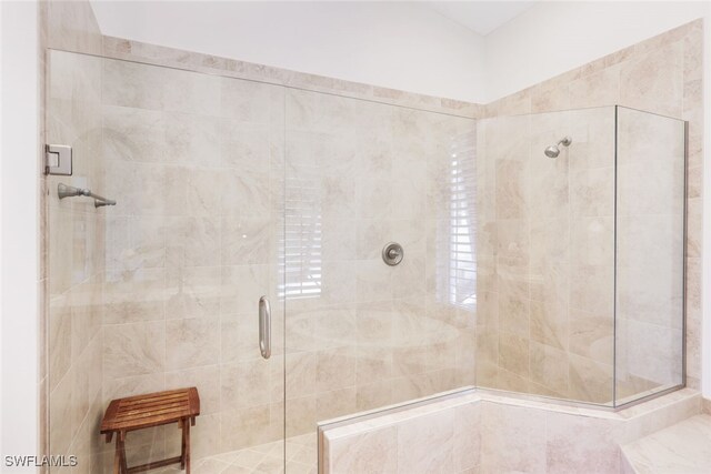 bathroom with a shower with shower door