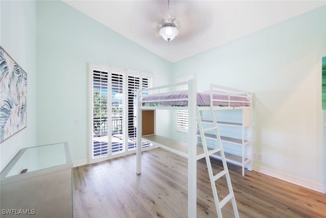 unfurnished bedroom with ceiling fan, wood-type flooring, and vaulted ceiling