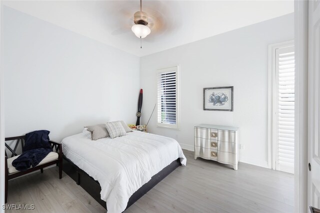 bedroom with light hardwood / wood-style flooring and ceiling fan