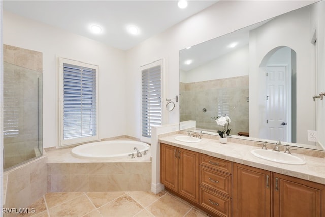 bathroom with vanity, tile patterned floors, and plus walk in shower