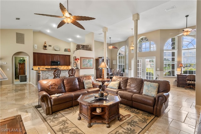 living room with ceiling fan and high vaulted ceiling