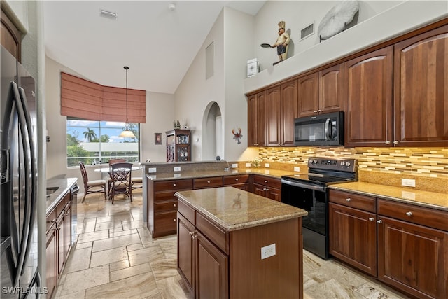 kitchen with pendant lighting, kitchen peninsula, a kitchen island, high vaulted ceiling, and black appliances