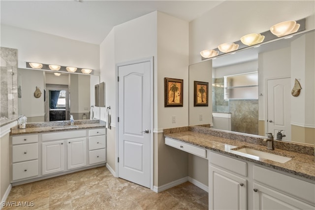 bathroom with vanity and tiled shower