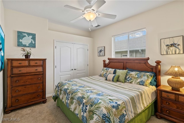 carpeted bedroom featuring ceiling fan and a closet