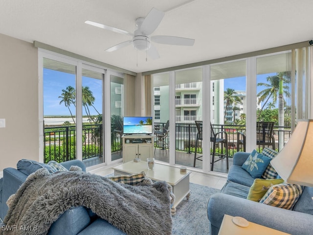 sunroom / solarium featuring ceiling fan