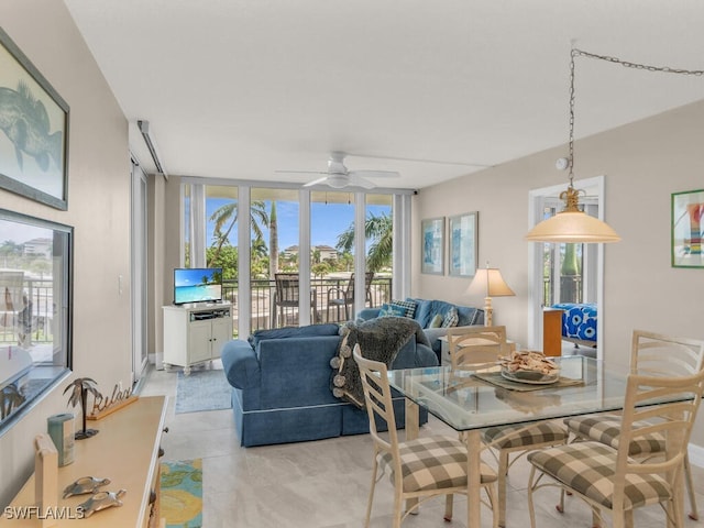 dining room with floor to ceiling windows and ceiling fan