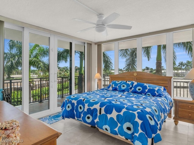 bedroom with ceiling fan, a wall of windows, a textured ceiling, and access to outside