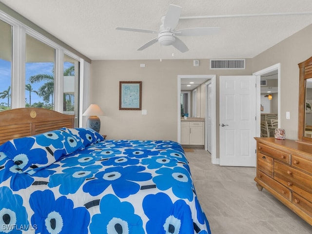 bedroom featuring ceiling fan and a textured ceiling