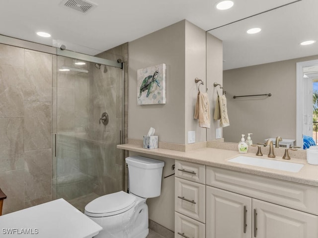 bathroom featuring vanity, toilet, and walk in shower