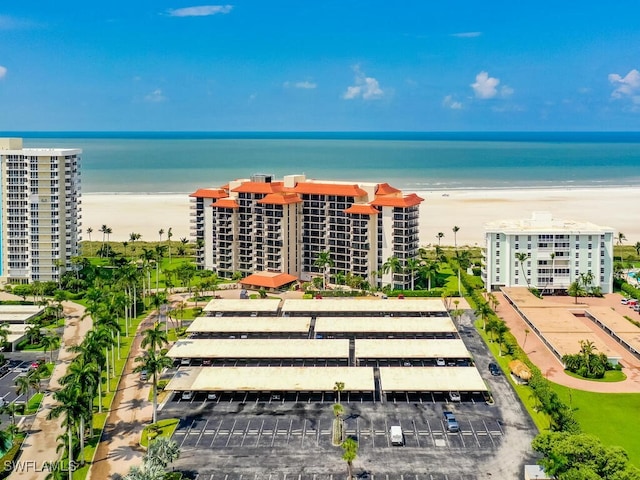 bird's eye view featuring a water view and a beach view