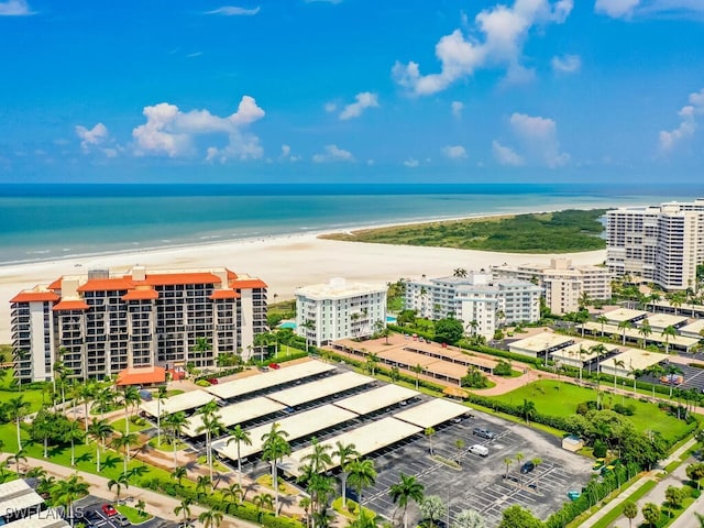 bird's eye view featuring a water view and a beach view