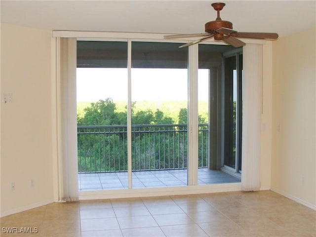 1001 Arbor Lake Dr Unit 203, Naples, FL 34110 - doorway featuring expansive windows, ceiling fan, baseboards, and tile patterned floors