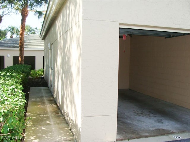 1001 Arbor Lake Dr Unit 203, Naples, FL 34110 - view of side of home featuring stucco siding
