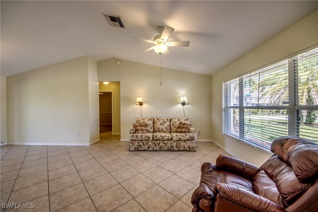 tiled living room featuring ceiling fan and lofted ceiling